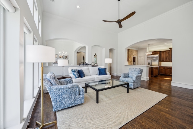 1675 Morris Ln, Frisco, TX 75034 - living room with ornamental molding, dark wood finished floors, arched walkways, a ceiling fan, and recessed lighting