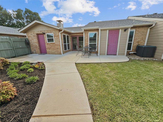 2114 Cottage Oak Ln, Colleyville, TX 76034 - rear view of house with brick siding, a patio, a chimney, cooling unit, and roof with shingles