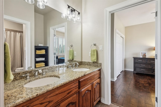 760 Del Carmen Dr, Prosper, TX 75078 - full bathroom with baseboards, double vanity, and wood finished floors