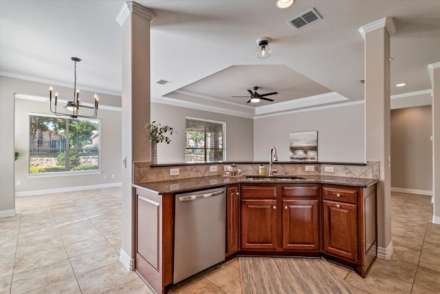 402 Pebble Beach Dr, Frisco, TX 75036 - kitchen featuring dishwasher, a sink, dark stone countertops, decorative columns, and a tray ceiling