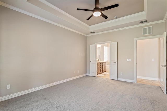402 Pebble Beach Dr, Frisco, TX 75036 - unfurnished bedroom featuring a raised ceiling, light carpet, ornamental molding, baseboards, and connected bathroom