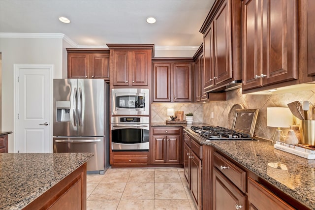 402 Pebble Beach Dr, Frisco, TX 75036 - kitchen with appliances with stainless steel finishes, ornamental molding, dark stone counters, decorative backsplash, and light tile patterned flooring