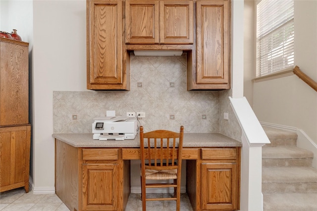 4301 Sandra Lynn Dr, Flower Mound, TX 75022 - kitchen with decorative backsplash, light countertops, brown cabinets, and light tile patterned floors