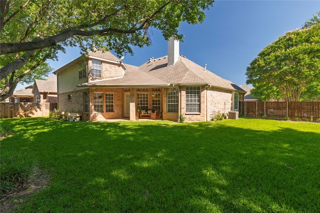 4301 Sandra Lynn Dr, Flower Mound, TX 75022 - back of property with brick siding, a chimney, central AC, a patio, and roof with shingles