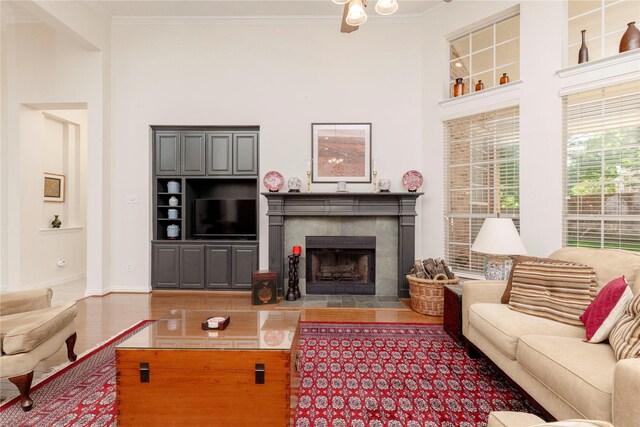 4301 Sandra Lynn Dr, Flower Mound, TX 75022 - living room featuring a high ceiling, ornamental molding, and a tiled fireplace