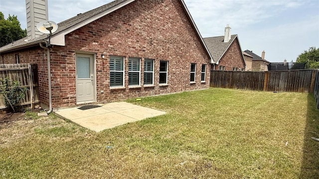 1924 Cliffrose Dr, Little Elm, TX 75068 - rear view of house featuring a chimney, brick siding, a patio, and roof with shingles