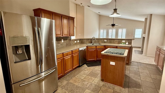 1924 Cliffrose Dr, Little Elm, TX 75068 - kitchen with appliances with stainless steel finishes, a sink, vaulted ceiling, tasteful backsplash, and a kitchen island