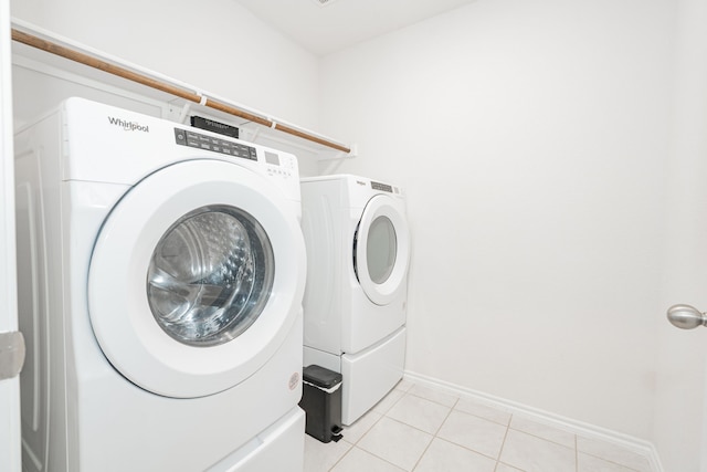 111 Seabiscuit Dr, Caddo Mills, TX 75135 - clothes washing area with washing machine and clothes dryer, light tile patterned floors, and baseboards