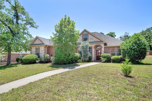 2920 Village Cir, Denison, TX 75020 - view of front of property with a front lawn, brick siding, and a shingled roof