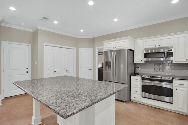 2920 Village Cir, Denison, TX 75020 - kitchen with appliances with stainless steel finishes, decorative backsplash, recessed lighting, white cabinets, and light stone counters