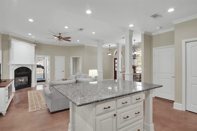 2920 Village Cir, Denison, TX 75020 - kitchen featuring ornate columns, crown molding, recessed lighting, a ceiling fan, and a glass covered fireplace