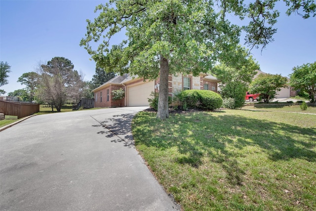 2920 Village Cir, Denison, TX 75020 - view of front of house with driveway, an attached garage, and brick siding