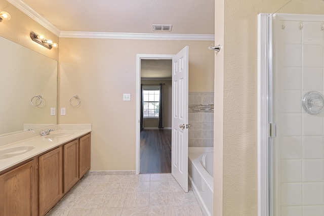6508 Corral Ln, Denton, TX 76210 - full bath featuring crown molding, tile patterned floors, double vanity, a tub to relax in, and baseboards