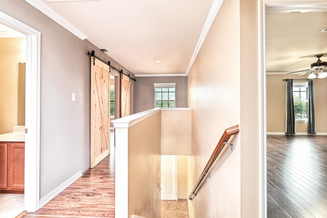 6508 Corral Ln, Denton, TX 76210 - hall featuring an upstairs landing, crown molding, wood finished floors, a barn door, and baseboards