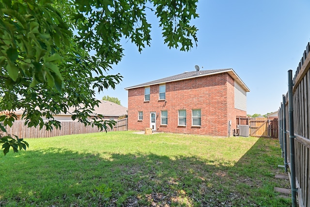 6508 Corral Ln, Denton, TX 76210 - rear view of property with brick siding, central AC unit, and a gate