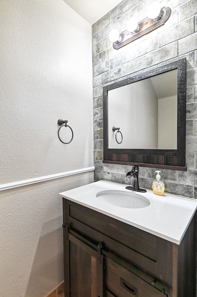 6508 Corral Ln, Denton, TX 76210 - bathroom with vanity and a textured wall