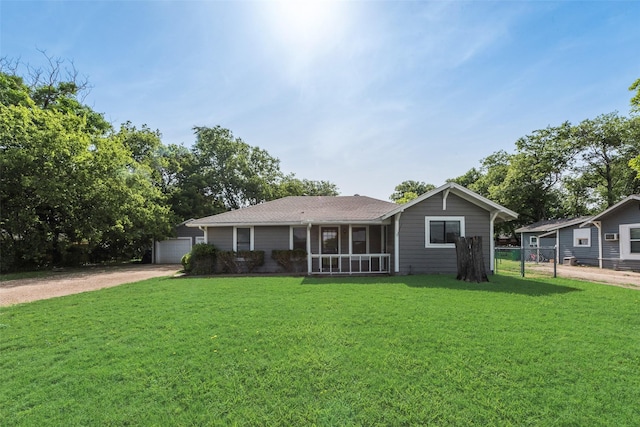 ranch-style house featuring driveway and a detached garage