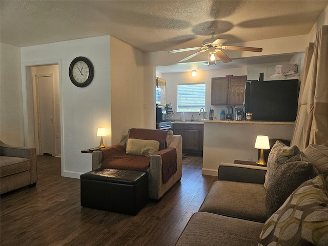 120 E Marguerita Dr, Garland, TX 75040 - living room with dark wood finished floors, a ceiling fan, a textured ceiling, and baseboards