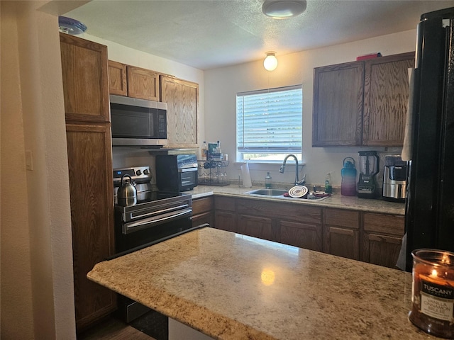 120 E Marguerita Dr, Garland, TX 75040 - kitchen with appliances with stainless steel finishes and a sink
