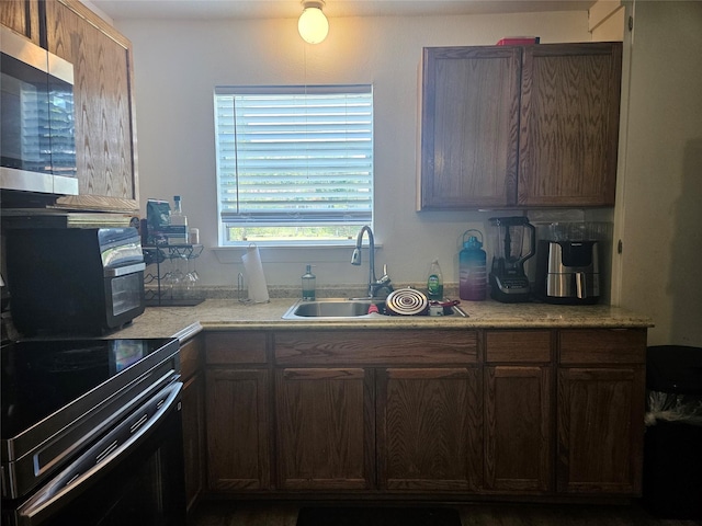 120 E Marguerita Dr, Garland, TX 75040 - kitchen featuring electric range, stainless steel microwave, a sink, and light countertops