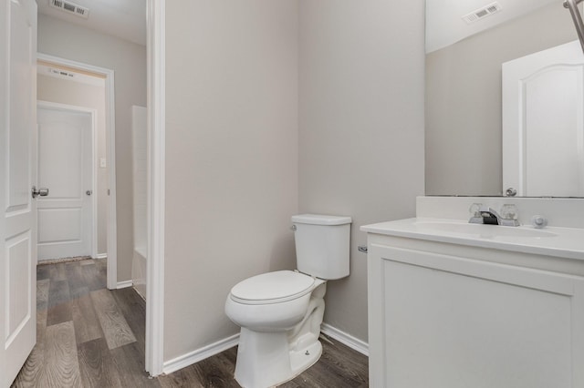 2109 Northridge Dr, Forney, TX 75126 - bathroom with wood finished floors, toilet, vanity, and baseboards