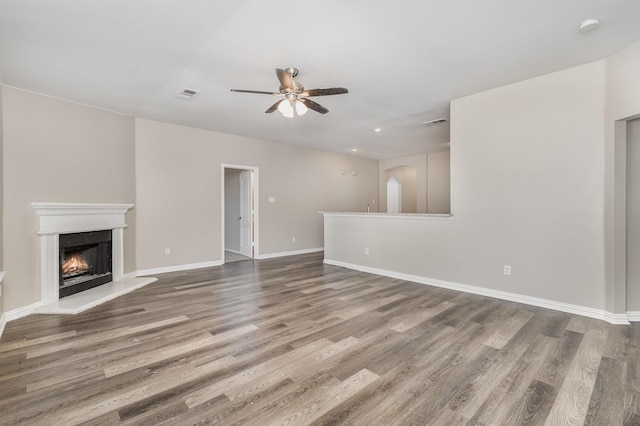 2109 Northridge Dr, Forney, TX 75126 - unfurnished living room featuring ceiling fan, wood finished floors, a lit fireplace, baseboards, and recessed lighting