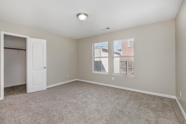 2109 Northridge Dr, Forney, TX 75126 - unfurnished bedroom with carpet flooring, baseboards, a closet, and a walk in closet