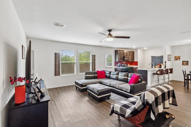 5645 Mcclelland St, Forney, TX 75126 - living room featuring wood finished floors, ceiling fan, baseboards, and recessed lighting