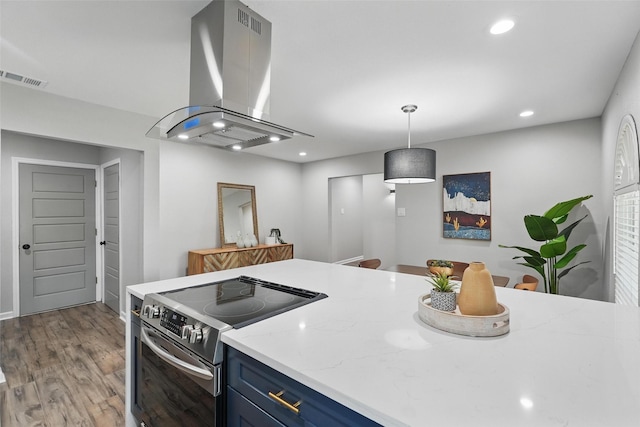 6005 Redwood Ln, Rowlett, TX 75089 - kitchen with stainless steel electric range, island exhaust hood, blue cabinetry, wood finished floors, and recessed lighting