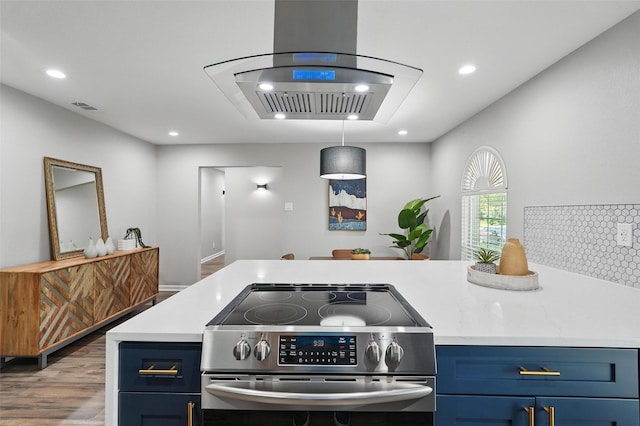 6005 Redwood Ln, Rowlett, TX 75089 - kitchen with stainless steel range with electric stovetop, blue cabinets, light countertops, wood finished floors, and recessed lighting