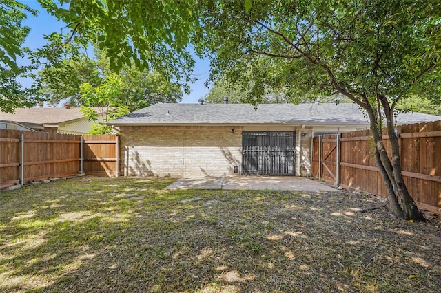 6005 Redwood Ln, Rowlett, TX 75089 - back of house featuring brick siding, a patio, and roof with shingles