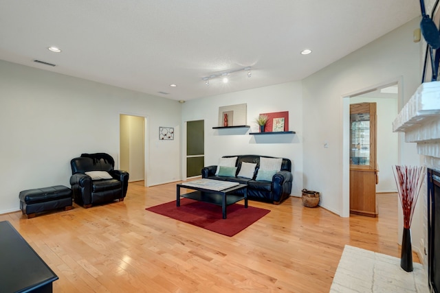 living room with light wood finished floors and recessed lighting
