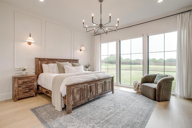 7758 Barber Ranch Rd, Fort Worth, TX 76126 - bedroom featuring a chandelier, light wood-style flooring, recessed lighting, and a decorative wall