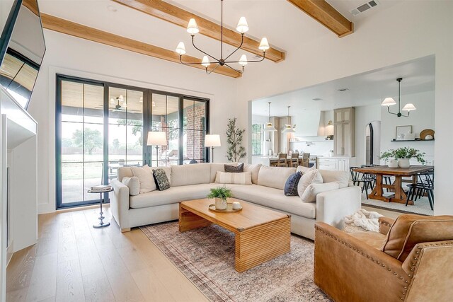 7758 Barber Ranch Rd, Fort Worth, TX 76126 - living room featuring beam ceiling, a chandelier, and light wood-style floors