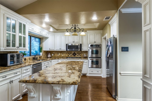 1950 Hidden Vly, Rockwall, TX 75087 - kitchen featuring appliances with stainless steel finishes, a sink, backsplash, dark wood-style flooring, and white cabinets