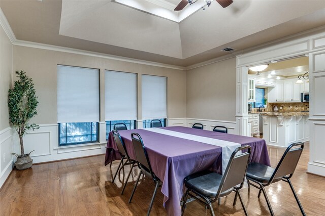 1950 Hidden Vly, Rockwall, TX 75087 - dining area featuring a raised ceiling, a ceiling fan, ornamental molding, a decorative wall, and light wood finished floors