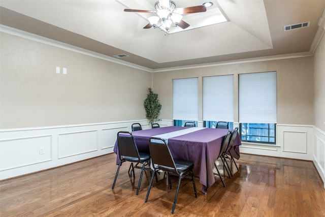 1950 Hidden Vly, Rockwall, TX 75087 - dining area featuring a raised ceiling, a ceiling fan, wood finished floors, a decorative wall, and ornamental molding
