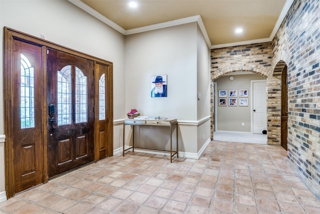 1950 Hidden Vly, Rockwall, TX 75087 - entryway featuring arched walkways, ornamental molding, brick wall, baseboards, and recessed lighting