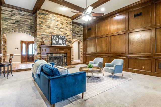 1950 Hidden Vly, Rockwall, TX 75087 - living room featuring arched walkways, a high ceiling, a brick fireplace, a ceiling fan, and beamed ceiling