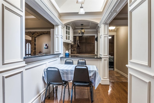 1950 Hidden Vly, Rockwall, TX 75087 - kitchen with ornate columns, white cabinets, backsplash, crown molding, and arched walkways