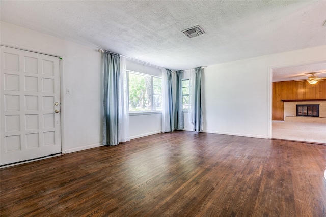 1405 Southwood Blvd, Arlington, TX 76013 - unfurnished living room with wood finished floors, a textured ceiling, ceiling fan, baseboards, and a glass covered fireplace