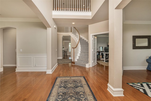 3001 Mason Dr, Plano, TX 75025 - entryway featuring arched walkways, wood finished floors, ornamental molding, stairway, and baseboards