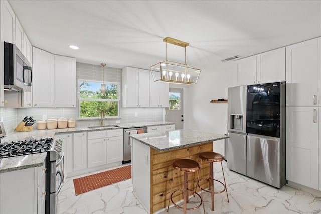 810 Turner Blvd, Grand Prairie, TX 75050 - kitchen featuring appliances with stainless steel finishes, light marble finish flooring, a sink, tasteful backsplash, and recessed lighting