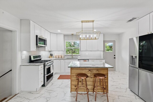 810 Turner Blvd, Grand Prairie, TX 75050 - kitchen featuring appliances with stainless steel finishes, light marble finish floors, healthy amount of natural light, tasteful backsplash, and recessed lighting