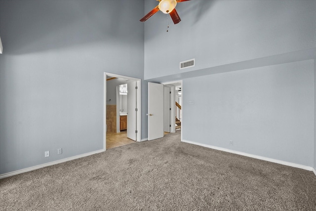 1206 Signal Ridge Pl, Rockwall, TX 75032 - unfurnished bedroom with light colored carpet, baseboards, a high ceiling, ensuite bathroom, and ceiling fan