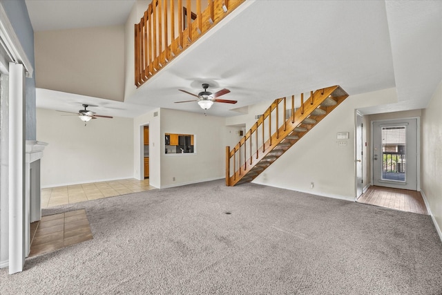 1206 Signal Ridge Pl, Rockwall, TX 75032 - unfurnished living room with stairway, ceiling fan, carpet flooring, and a fireplace