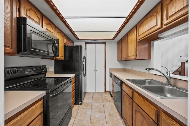 1206 Signal Ridge Pl, Rockwall, TX 75032 - kitchen featuring black appliances, a sink, light countertops, brown cabinetry, and light tile patterned floors