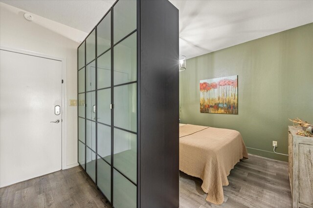 401 E Pearl St Unit 2105, Granbury, TX 76048 - bedroom featuring wood finished floors