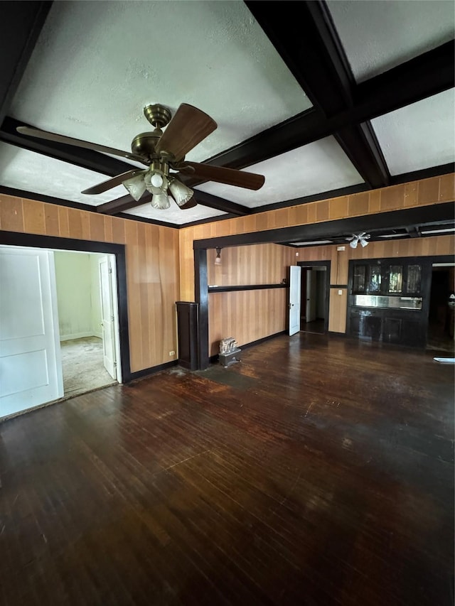 1205 W Arlington Ave, Fort Worth, TX 76110 - unfurnished living room featuring a ceiling fan, wood walls, beam ceiling, dark wood finished floors, and coffered ceiling
