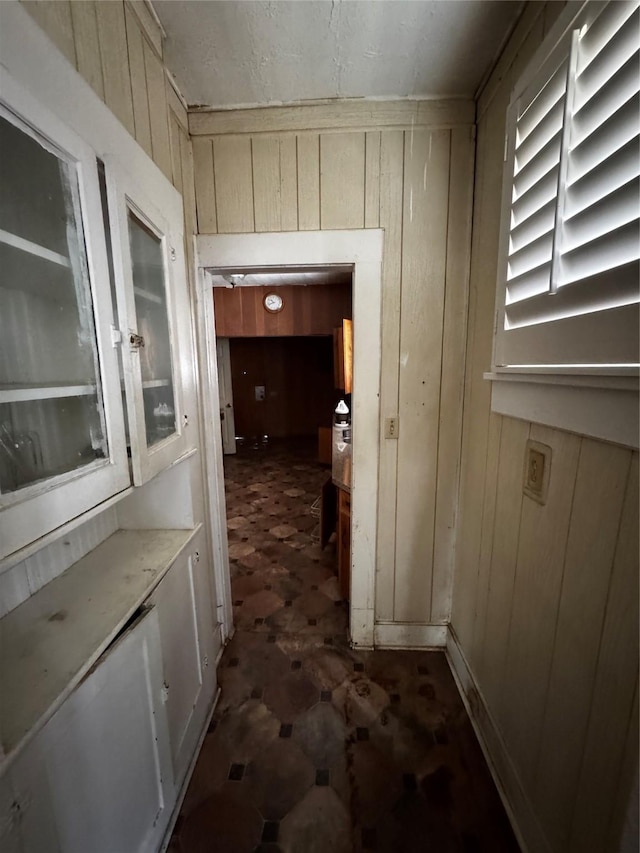 1205 W Arlington Ave, Fort Worth, TX 76110 - hall featuring dark flooring and wooden walls